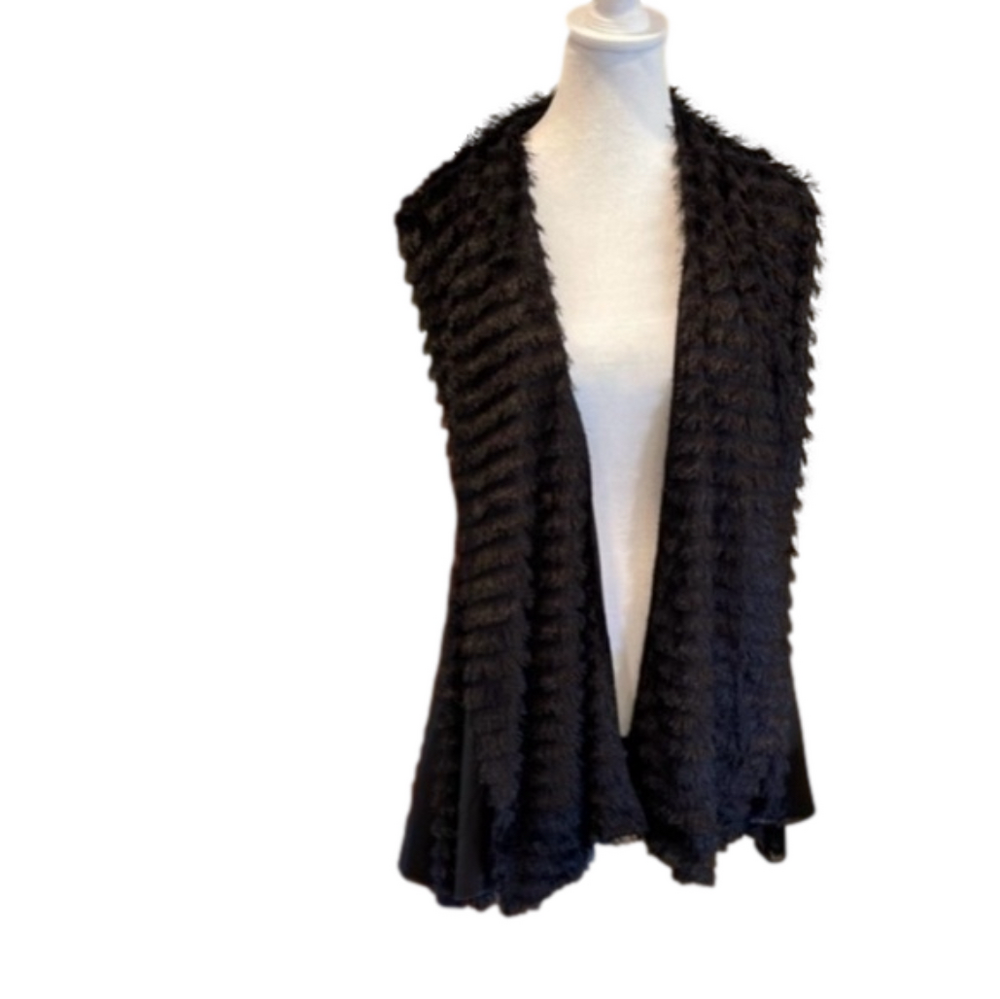 Small/medium but fits larger. Fabulous zipper detail  and fringe.